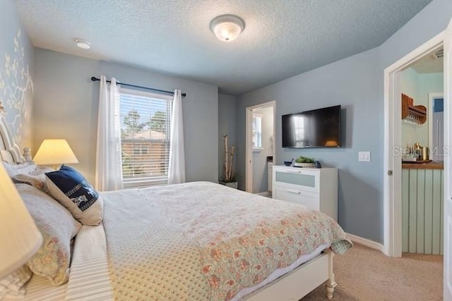 carpeted bedroom featuring a textured ceiling