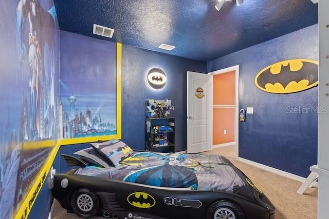 carpeted bedroom featuring a textured ceiling