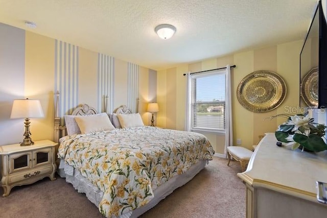 bedroom with a textured ceiling and carpet floors