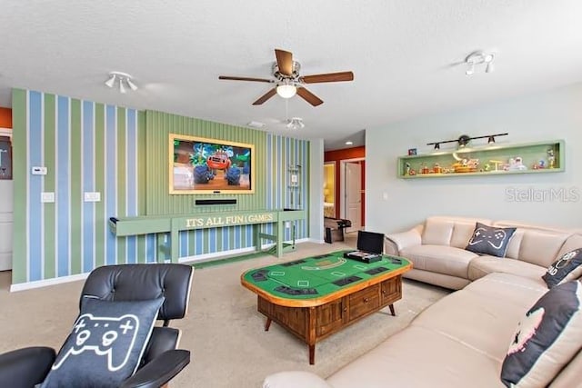 carpeted living room featuring a textured ceiling and ceiling fan