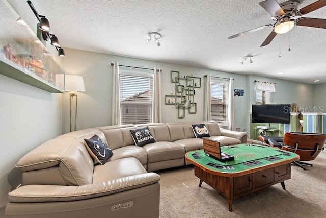 carpeted living room with a textured ceiling and ceiling fan