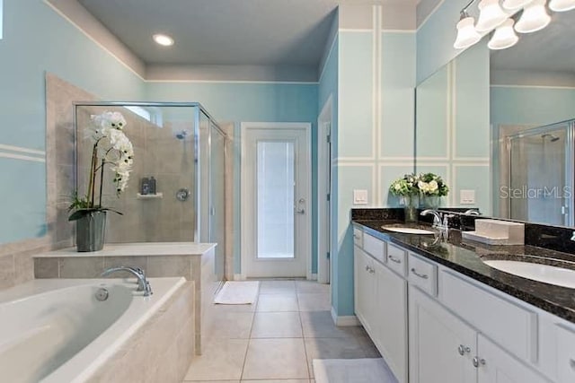 bathroom with tile floors, dual bowl vanity, and shower with separate bathtub