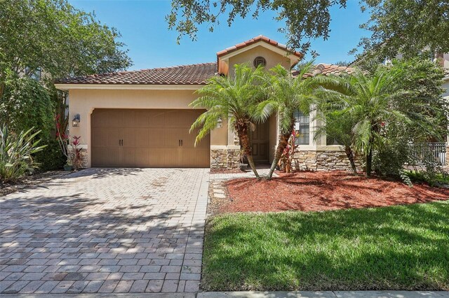 mediterranean / spanish-style home with a garage