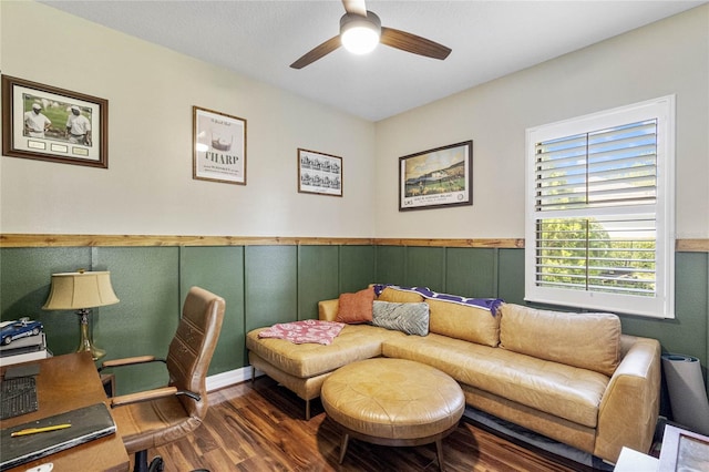 living room with ceiling fan and dark wood-type flooring