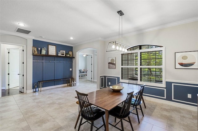 dining space featuring a textured ceiling, crown molding, and light tile patterned flooring