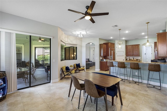 dining space with ceiling fan and light tile patterned flooring