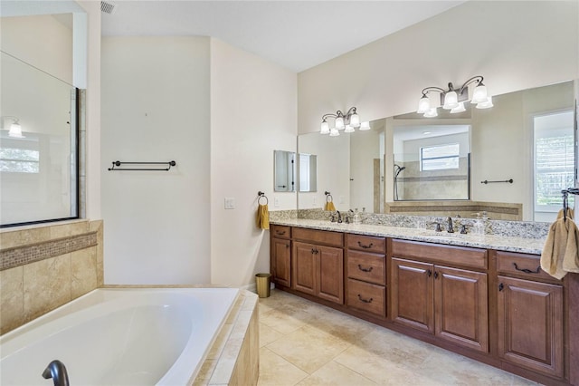 bathroom featuring vanity and shower with separate bathtub