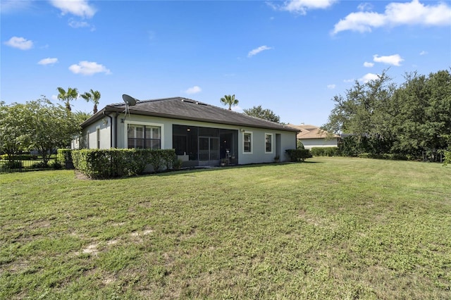 rear view of house with a lawn