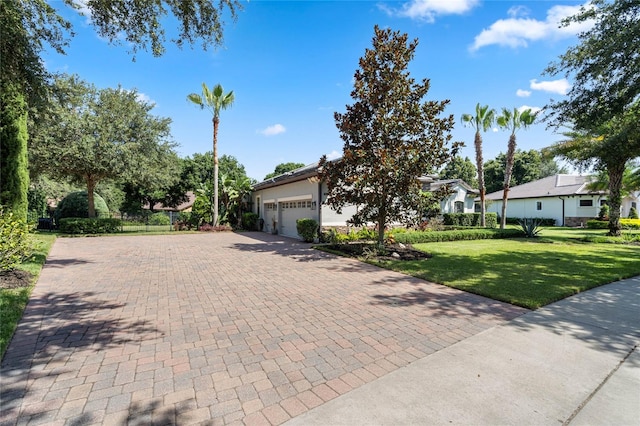 view of front facade with a garage and a front lawn