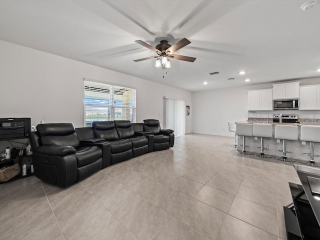 tiled living room with ceiling fan