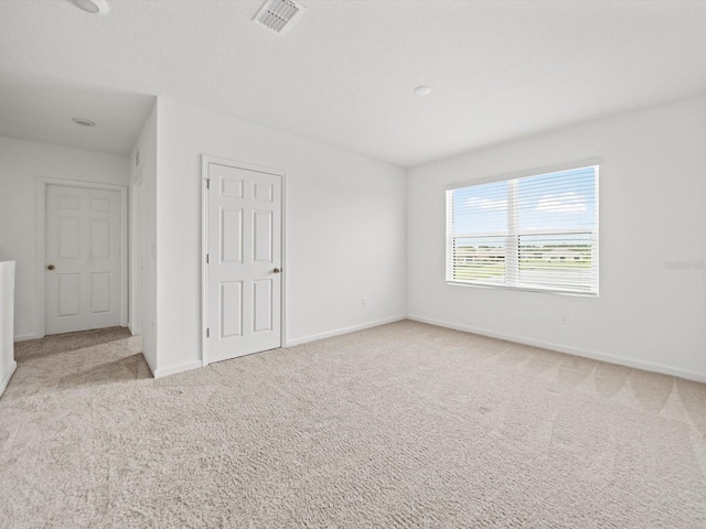 unfurnished room with light carpet