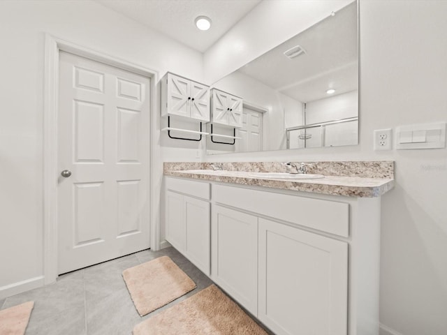 bathroom with vanity, tile patterned floors, and walk in shower