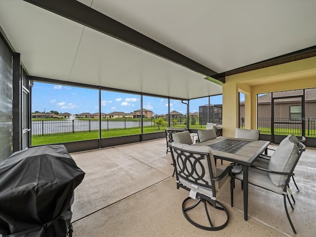 sunroom with beam ceiling and a wealth of natural light