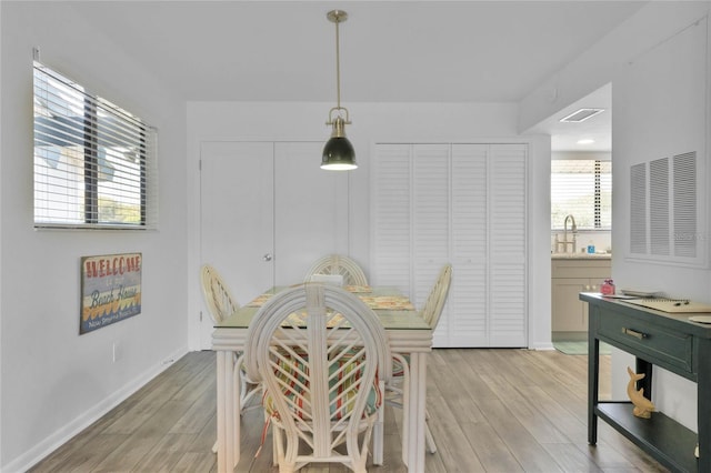 dining area featuring light hardwood / wood-style flooring and sink