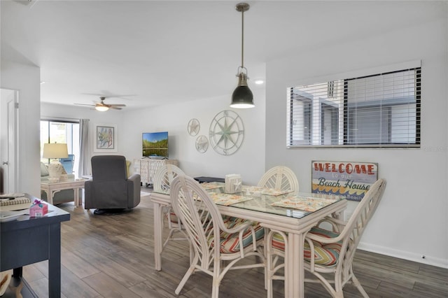 dining area featuring ceiling fan and dark wood-type flooring