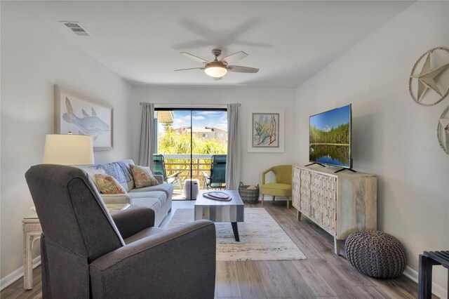 living room featuring hardwood / wood-style flooring and ceiling fan