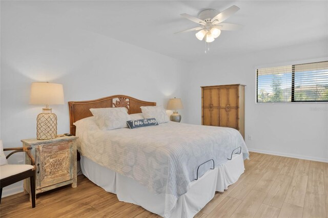 bedroom with ceiling fan and light hardwood / wood-style floors