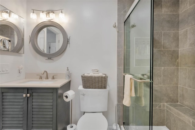 bathroom featuring vanity, toilet, and an enclosed shower