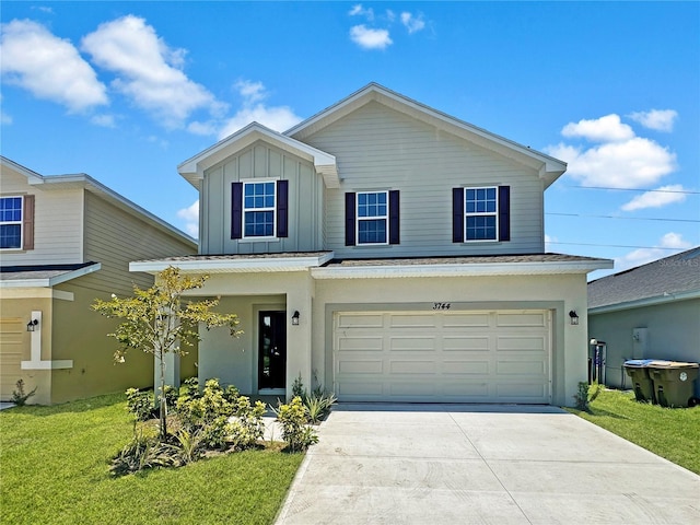 view of front of property featuring a front lawn and a garage