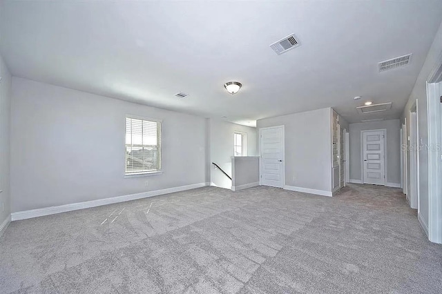 unfurnished room featuring light carpet