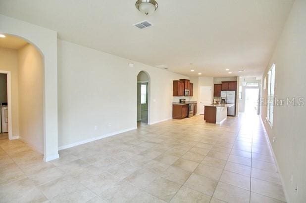 unfurnished living room featuring light tile patterned flooring