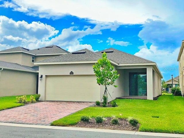 view of front facade with a front yard and a garage