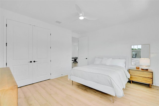 bedroom with a closet, ceiling fan, and hardwood / wood-style floors