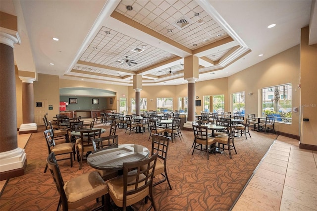 dining space with beam ceiling, a towering ceiling, coffered ceiling, ceiling fan, and light tile floors