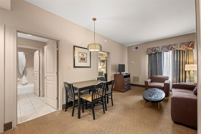 dining room featuring light carpet