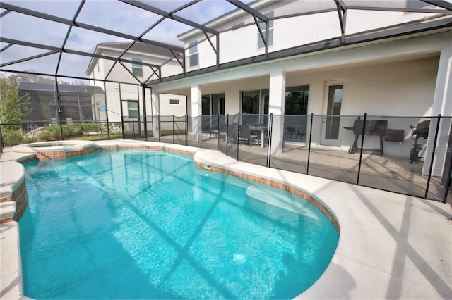 view of swimming pool with glass enclosure, an in ground hot tub, and a patio