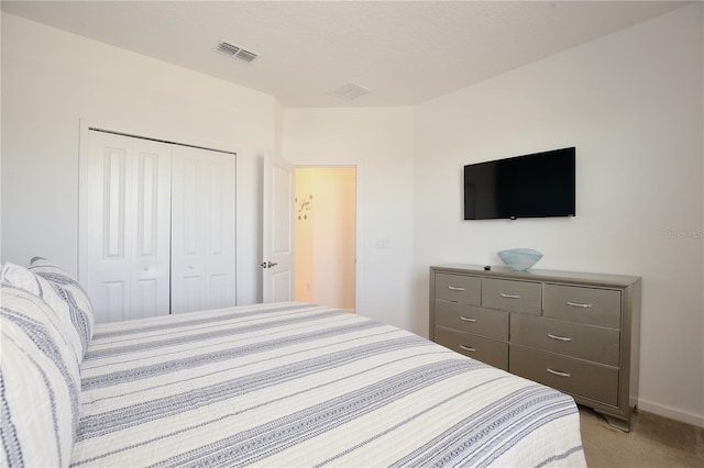 carpeted bedroom with a closet