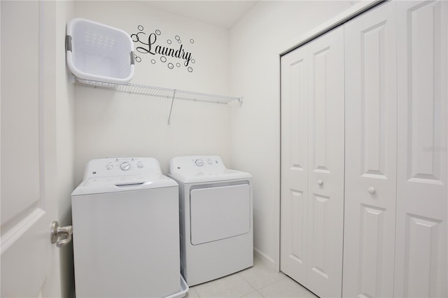 laundry area featuring independent washer and dryer and light tile patterned floors