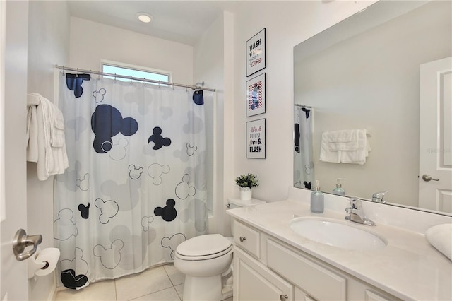 bathroom featuring tile patterned floors, vanity, and toilet