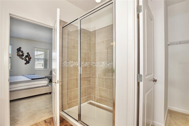 bathroom featuring wood-type flooring and an enclosed shower