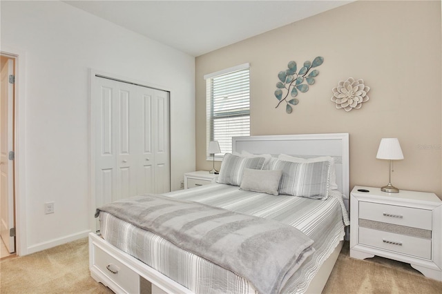 bedroom featuring light colored carpet and a closet