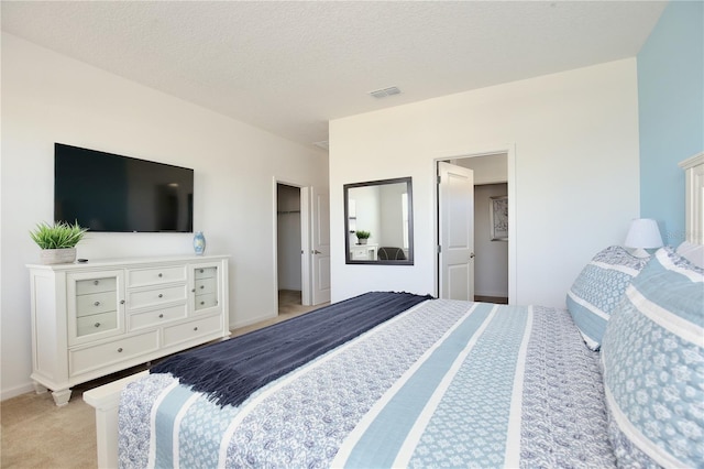 carpeted bedroom featuring a textured ceiling