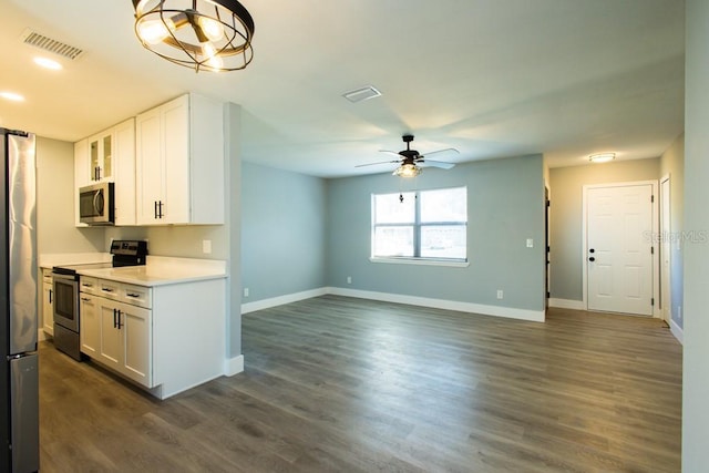 4230 Ponds Dr, Cocoa, FL 32927 - kitchen featuring appliances with stainless steel finishes, white cabinets, light countertops, baseboards, and dark wood-style flooring
