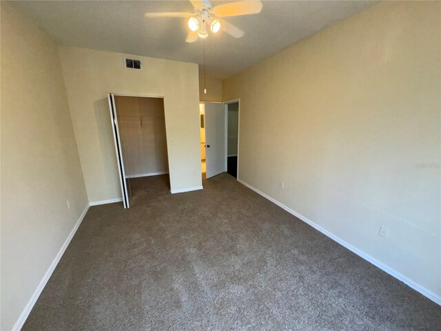 unfurnished bedroom featuring carpet flooring, ceiling fan, and a closet