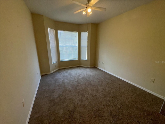 spare room featuring carpet flooring and ceiling fan