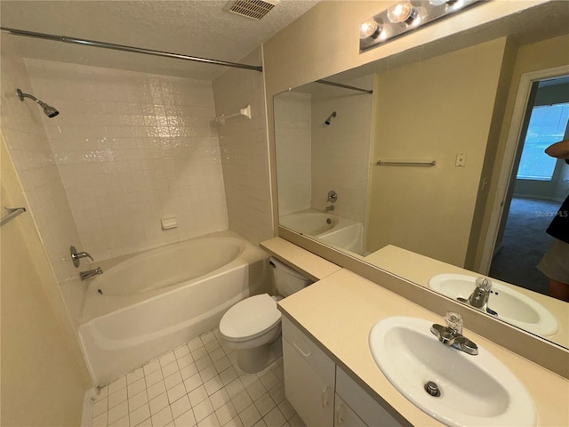 full bathroom featuring tile patterned floors, bathtub / shower combination, vanity, a textured ceiling, and toilet