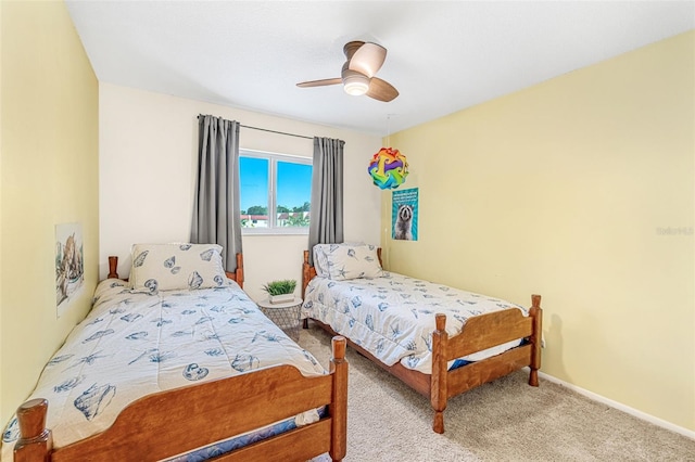 carpeted bedroom with a ceiling fan and baseboards