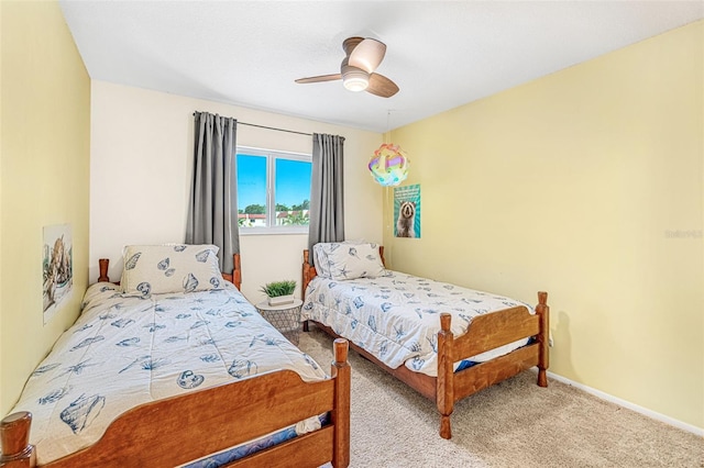 bedroom with a ceiling fan, carpet, and baseboards