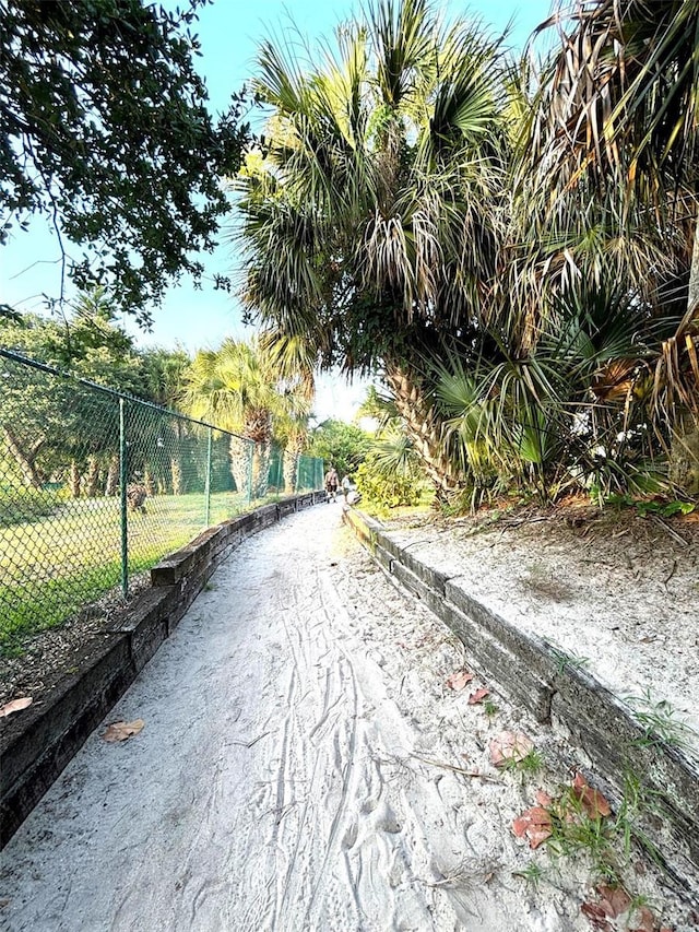 view of property's community featuring fence