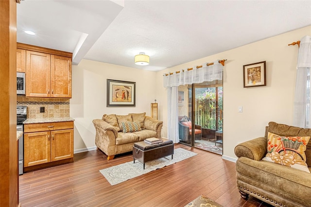 living area with light wood-style flooring and baseboards