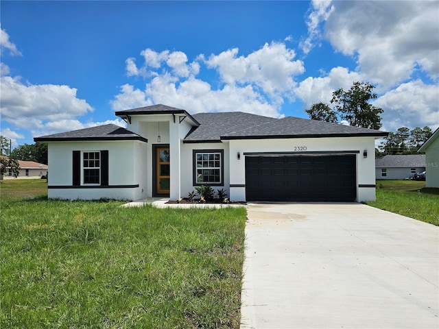 view of front of house with a front yard and a garage