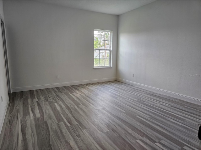 spare room with dark wood-type flooring