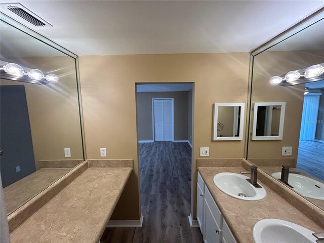 bathroom featuring hardwood / wood-style floors and double sink vanity