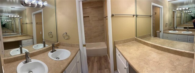 bathroom featuring hardwood / wood-style flooring and dual bowl vanity