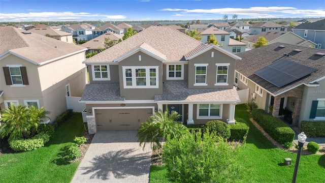 view of front of home featuring a front lawn and a garage