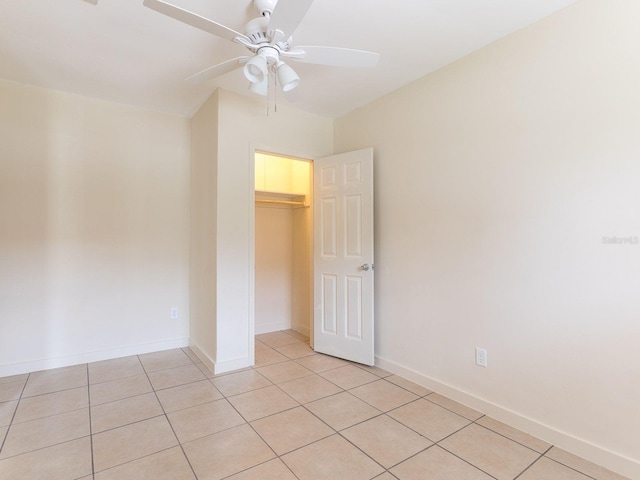 tiled spare room featuring ceiling fan